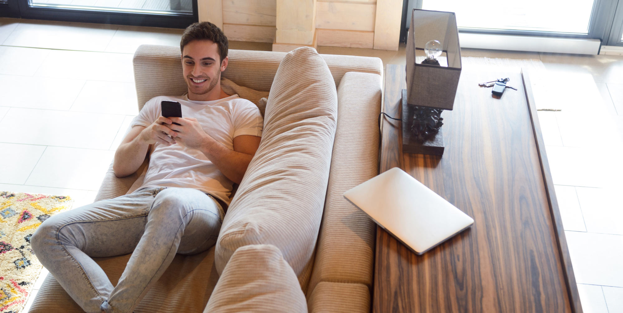 https://flame-tec.com/wp-content/uploads/2021/01/Man-on-sofa-with-phone.jpg